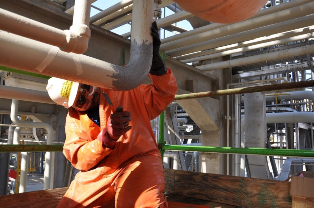 Industrial Metal Epoxy Paste is applied to a pipe elbow joint in Saudi Arabia to reinforce a weakened 100mm sulphuric acid line