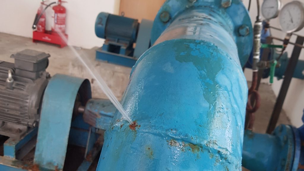 A pressurised jet of water escaping from a 150mm pipe elbow in a Malaysia pumping station