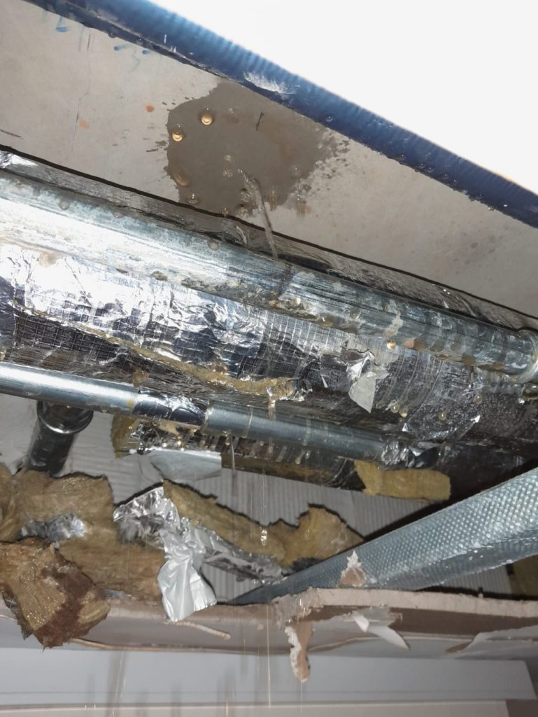 A pinhole leak in a 50mm steel pipe in a district heating system prior to being repaired with a SylWrap Pipe Repair Contractor Case