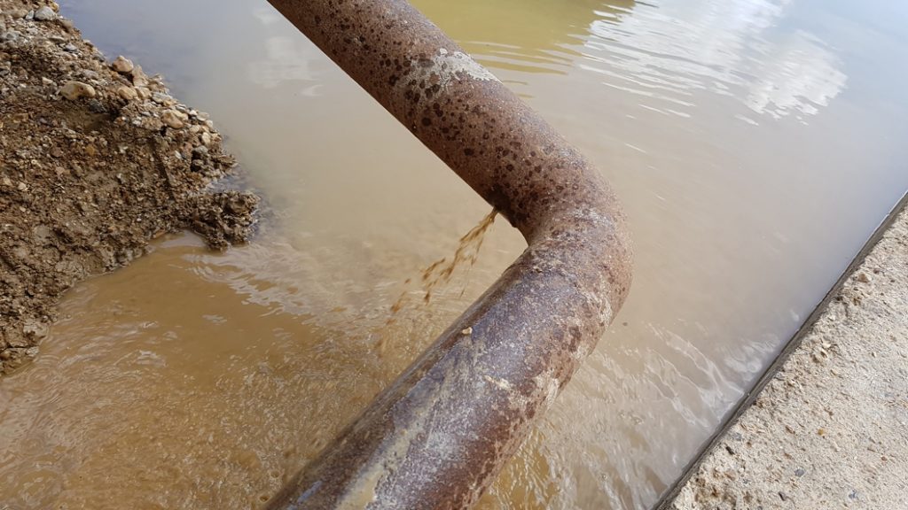 A leaking elbow bend on a 150mm steel pipe at a quarry wash plant before undergoing repair with a SylWrap Standard Pipe Repair Kit