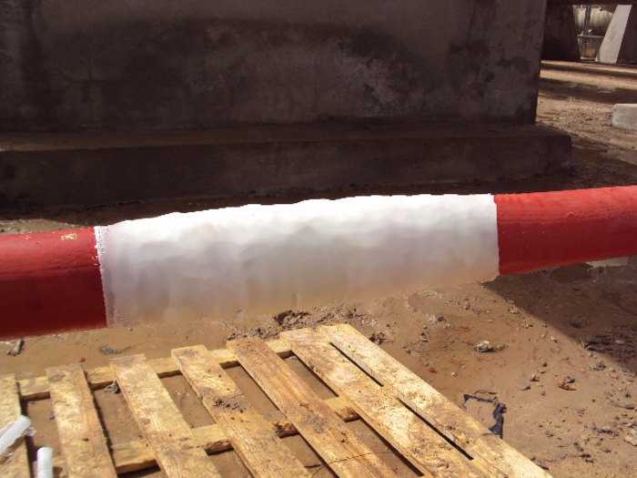 A SylWrap HD Pipe Repair Bandage applied to an above ground water supply line as part of a live leak repair