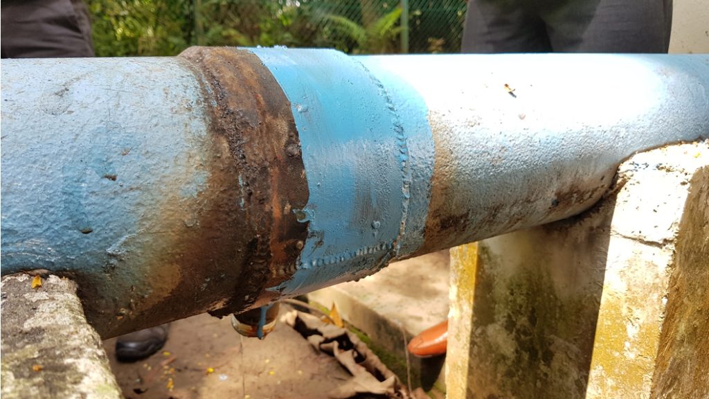 A 150mm steel pipe with a heavily corroded saddle joint prior to undergoing leak repair