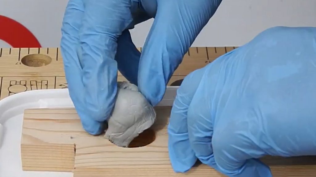 Sylmasta AB Original Epoxy Putty Stick used to repair deep holes in a wooden demo piece