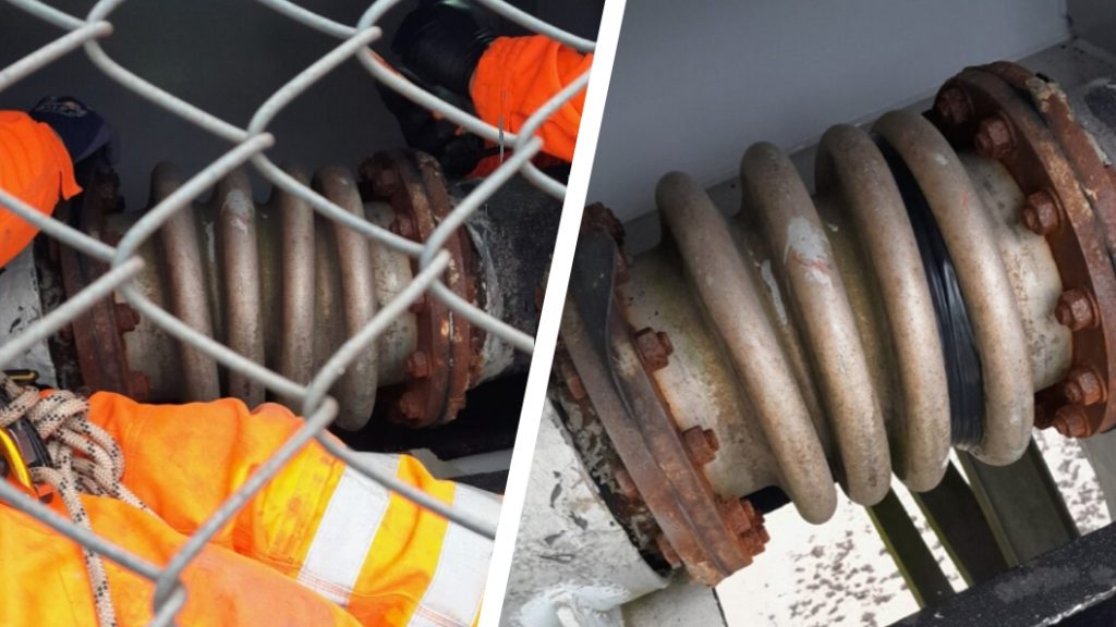 A leaking expansion joint on a 225mm steel water main pipe undergoes repair with Wrap & Seal Pipe Burst Tape