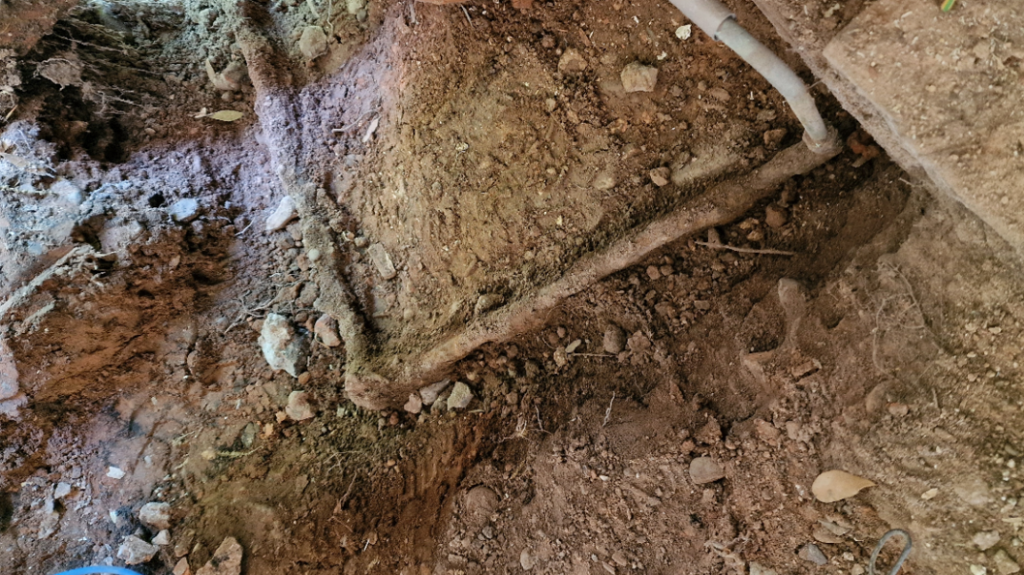 Heavily corroded domestic water main supply pipe also imbedded with stones before a Sylmasta repair sealed and refurbished the line