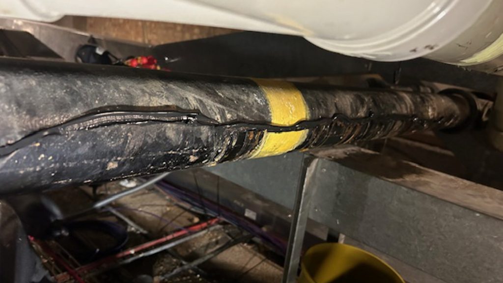 CrackSeal Cast Iron Pipe Sealant extruded into a soil pipe in a repair made at a hospital