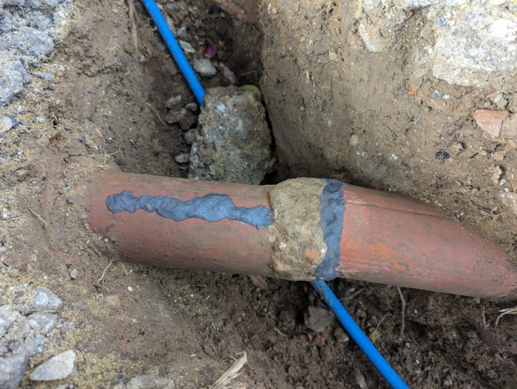 Superfast Steel Epoxy Putty used to repair cracks in an underground clay drainage pipe