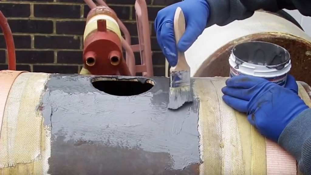 Liquid Metal Epoxy Coating being brush applied to carbon steel to show how easy it is to to repair and refubish metalwork attacked by corrosion