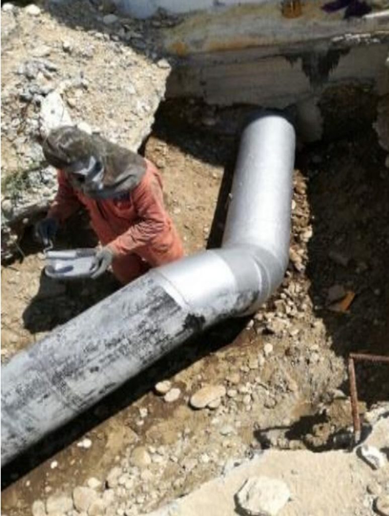 Liquid Metal Epoxy Coating painted onto a pipe during repair and refurbishment at a wastewater treatment plant in Mexico