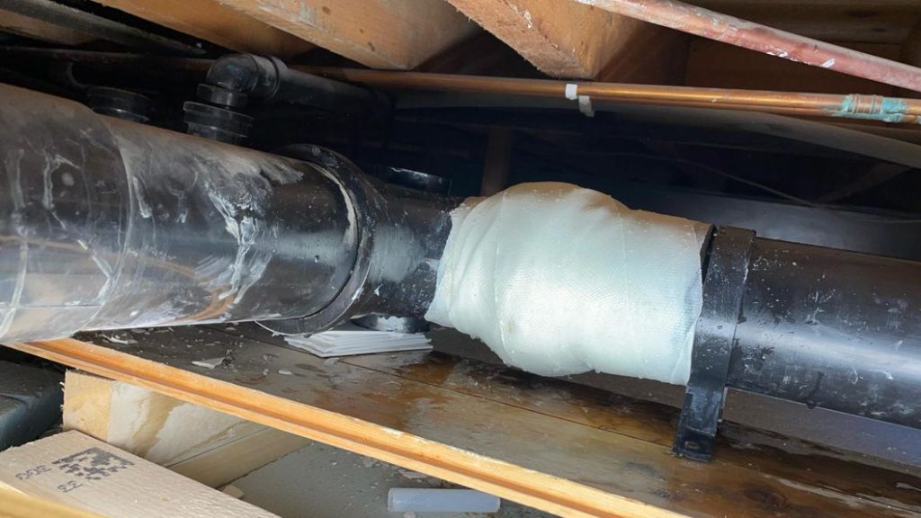 Completed repair of a plastic pipe joint leak caused by weakened solvent cement 